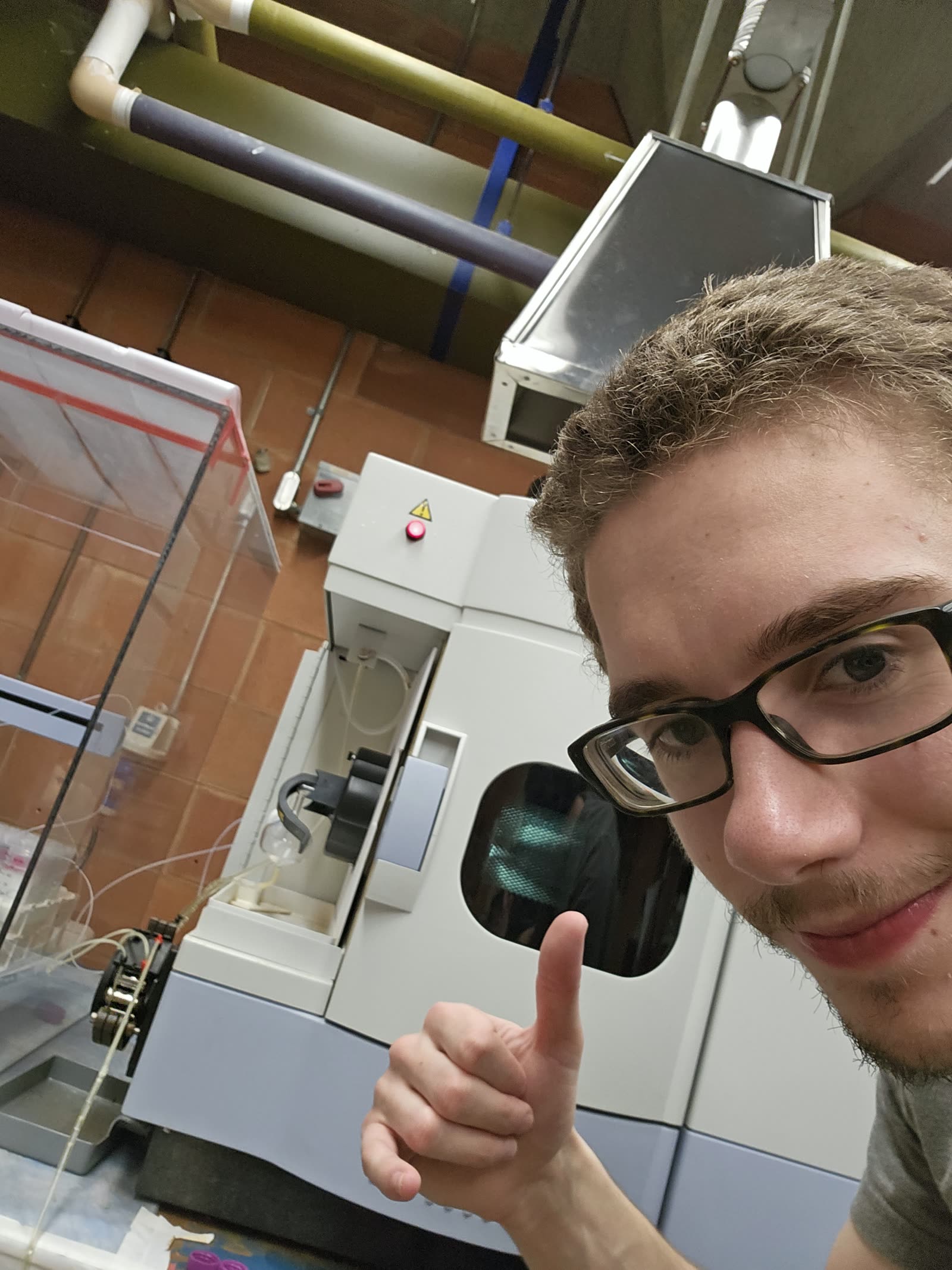 Neil giving a thumbs-up in a lab